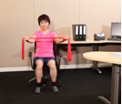 Stretching arms sideways; seated
